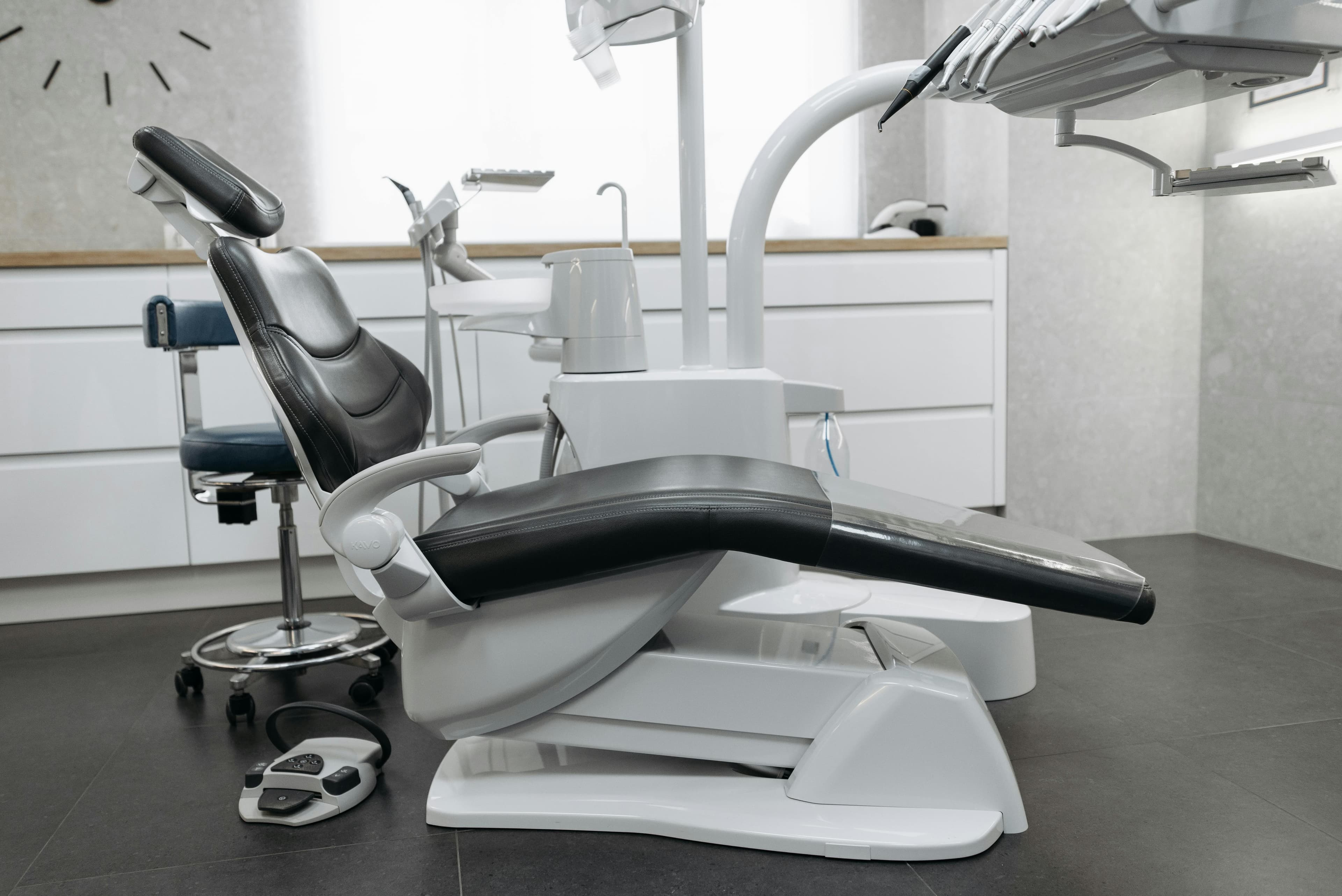 A contemporary dental office with a sleek dental chair and equipment, perfect for healthcare themed needs.