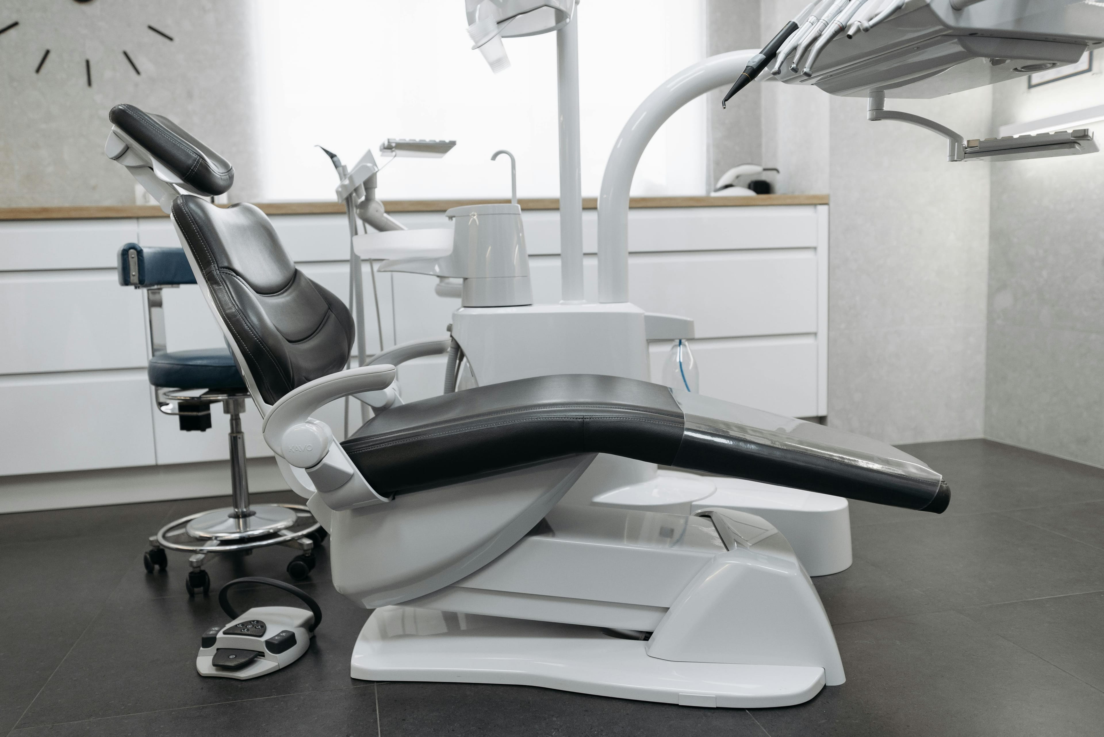 A contemporary dental office with a sleek dental chair and equipment, perfect for healthcare themed needs.